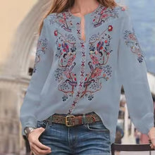 Load image into Gallery viewer, Light blue embroidered blouse worn by a person with a blurred background