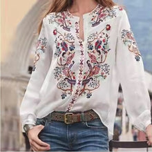 Load image into Gallery viewer, White blouse with colorful embroidery worn by a person, blurred background