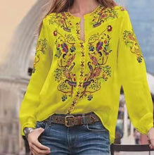 Load image into Gallery viewer, Person wearing a bright yellow embroidered blouse with a blurred background