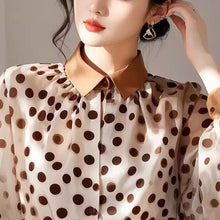 Load image into Gallery viewer, Woman wearing a polka dot blouse with a brown collar against a neutral background
