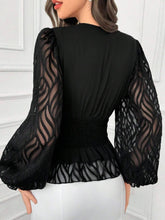 Load image into Gallery viewer, Black blouse with sheer sleeves on a white background