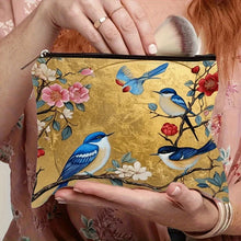 Load image into Gallery viewer, Hand holding a makeup pouch with floral and bird design