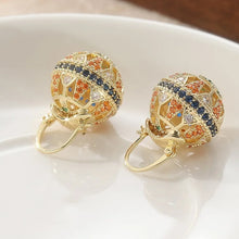 Load image into Gallery viewer, Gold earrings with multicolored gemstones on a white surface