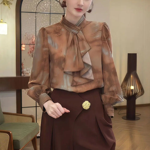Woman wearing a brown blouse with a bow and skirt