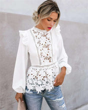Load image into Gallery viewer, A woman wearing a white long-sleeved blouse with lace floral hollow-out detailing and an O-neck collar, paired with blue ripped jeans.
