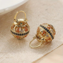 Load image into Gallery viewer, Gold earrings with colorful gemstones on a textured surface
