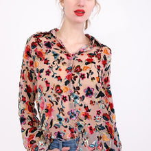 Load image into Gallery viewer, A woman wearing a mid-length, sleeveless, floral embroidery blouse with a round neckline.
