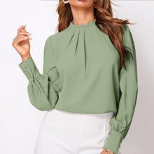 Load image into Gallery viewer, A woman wearing a green pleated mock-neck chiffon blouse with full sleeves and a loose fit.
